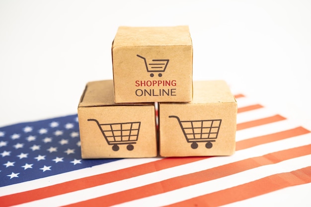 Scatola con il logo del carrello online e la bandiera usa america import export shopping online o commercio finanza servizio di consegna negozio prodotto spedizione commercio fornitore concetto