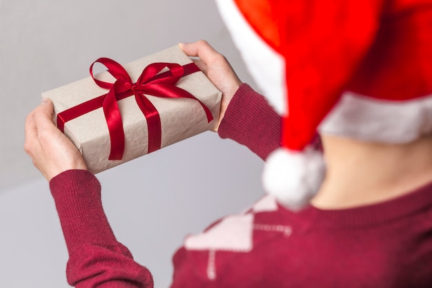 A box with a surprise for Christmas in the hands of a girl.