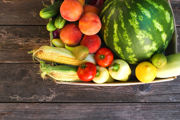 Box with vegetables and fruits on the old wood Top view. Flat lay.