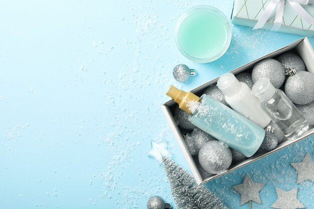 Box with winter cosmetics on blue background
