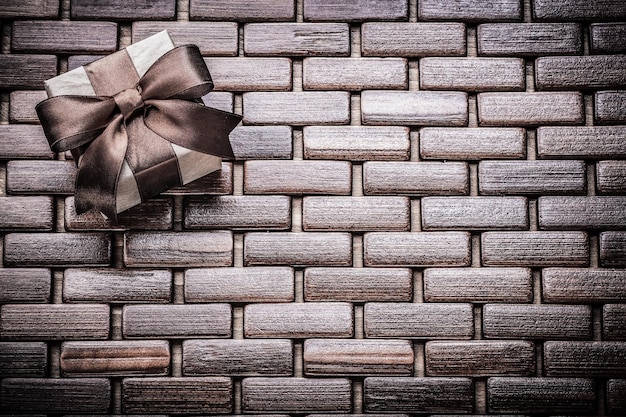 Boxed present box on wooden wicker mat holidays concept