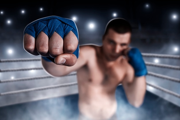 Boxer in blue wrist wraps on the training.