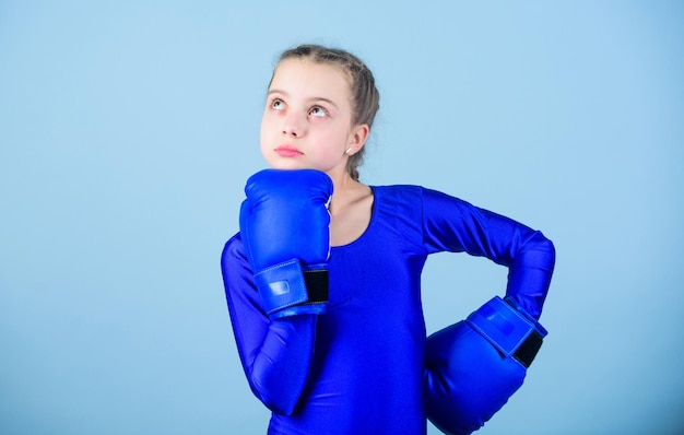 Boxer child in boxing gloves Female boxer change attitudes within sport Rise of women boxers Girl cute boxer on blue background With great power comes great responsibility Contrary to stereotype