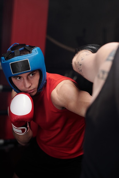 Photo boxer in helmet hitting his rival