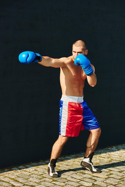 Boxer shorts and gloves practicing on the street