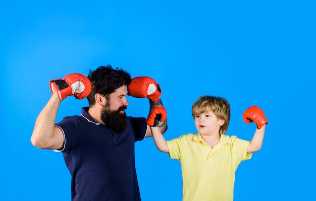 Boxer trainer is training new little boy boxer for competitions little boxer boy exercising at