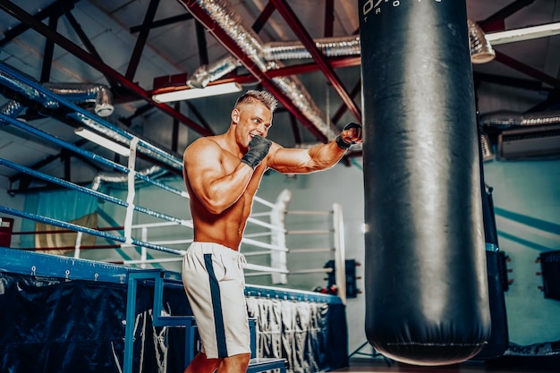 Boxer training on a punching bag in the gym