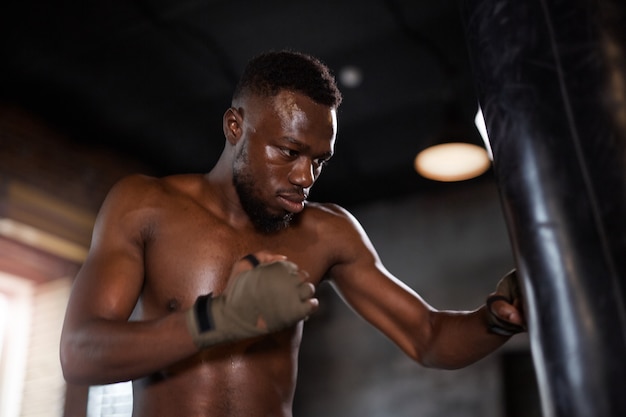 Boxer training with punching bag