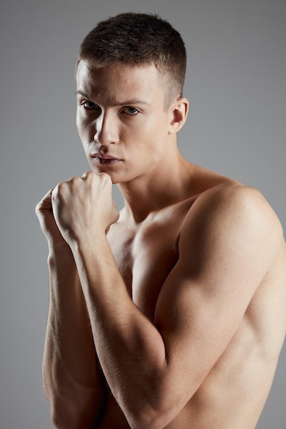 Boxer with fist on gray background closeup portrait