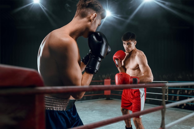 Boxers man fighting in ring