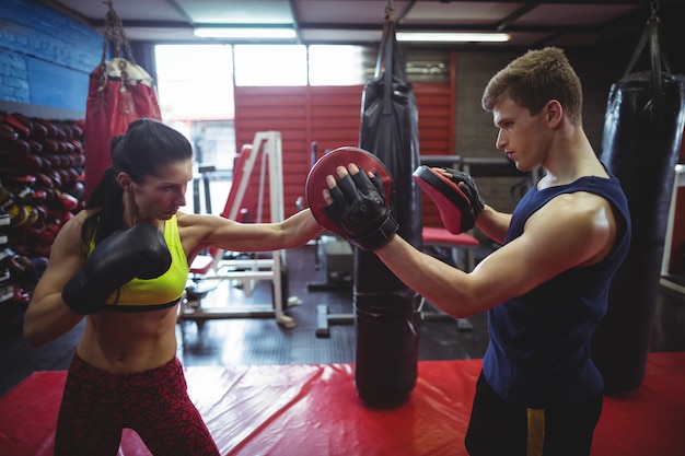 Boxers using focus mitts during training