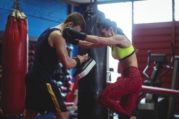 Boxers using focus mitts during training