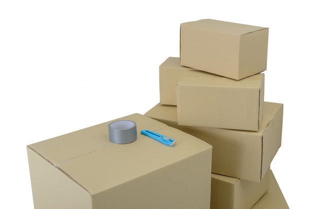 Boxes in different sizes stacked boxes, Adhesive tape and Cutter isolated on white backgrouns