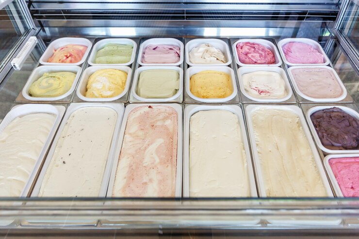 Photo boxes of different types and tastes of ice cream in a modern store