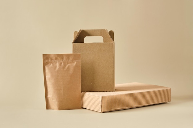 Boxes and paper zip bags on a beige background mockup packaging
for products packages for delivery ecofriendly natural materials
co2 neutral