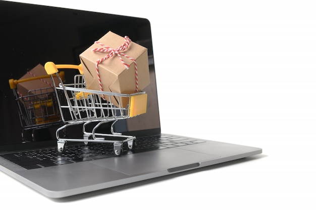 Boxes in a trolley on a laptop keyboard isolated 