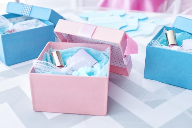 Boxes with baby shower favors on table