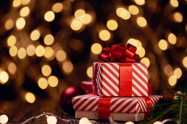 Boxes with Christmas gifts on a festive background.