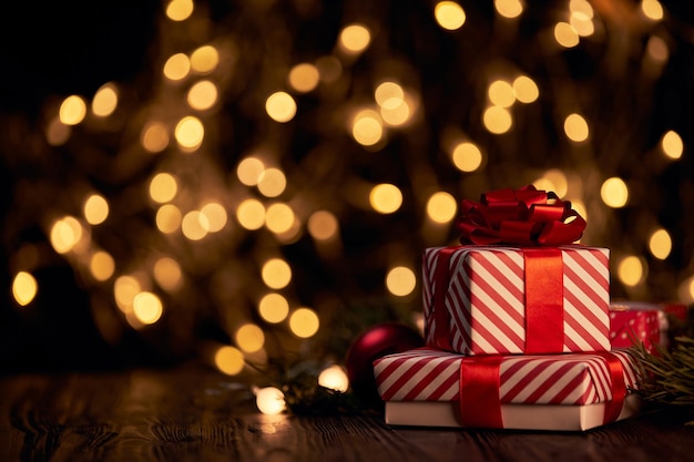 Boxes with Christmas gifts on a festive background.