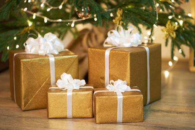 Boxes with christmas gifts in golden color wrapping paper