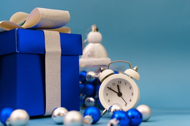 Boxes with gifts and christmas tree blue toys with clock, christmas holidays time concept