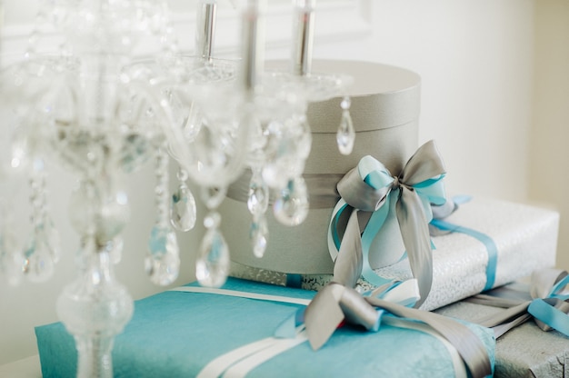 Boxes with gifts Packed in blue and silver paper are on the shelf