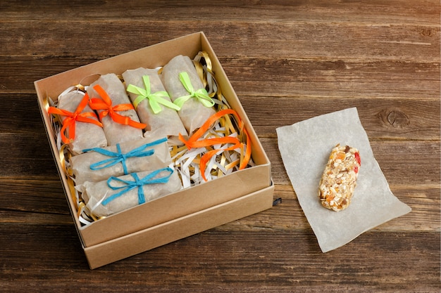 Boxes with packaged bars. One open. Wooden table. 