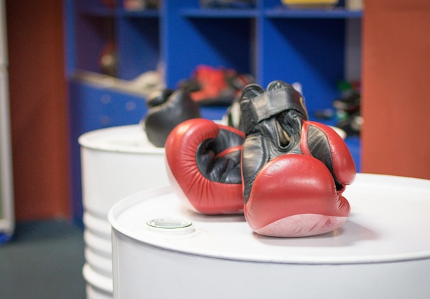 Photo boxing gloves in the gym for boxing training the concept of strength sport