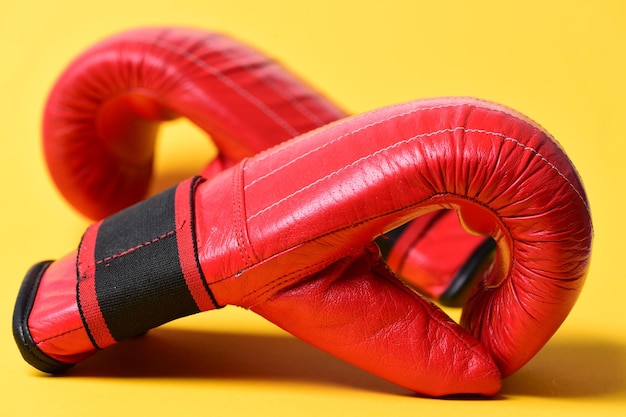 Boxing gloves in red color on yellow background