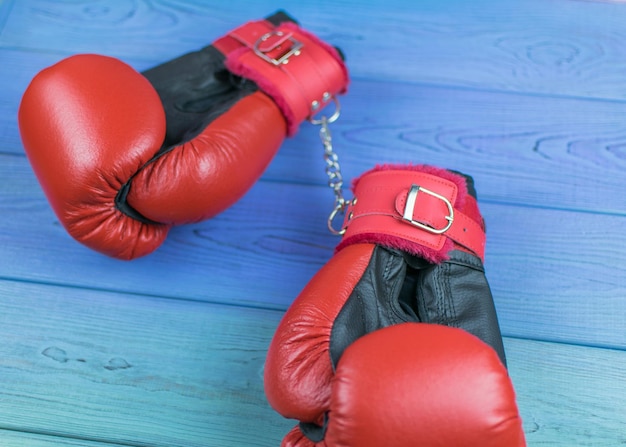 Boxing gloves tied with handcuffs Glamorous boxing concept