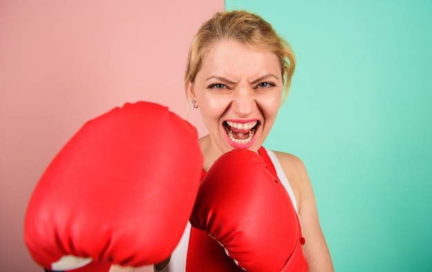 Boxing improve temper and will Woman boxing gloves focused on attack Ambitious girl fight boxing gloves Female rights I am gonna kick you off Confident in her boxing skill Concentrated on punch