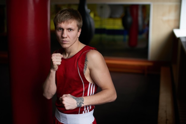 Boxing. Portrait of a boxer on the background of the gym