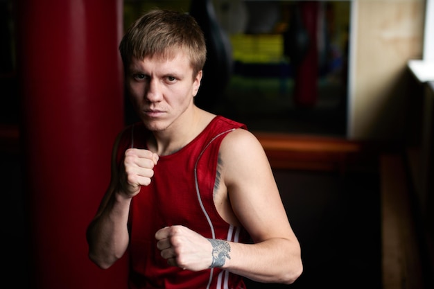 Boxing. Portrait of a boxer on the background of the gym