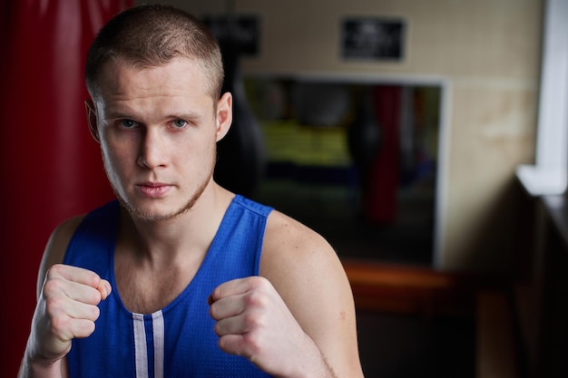 Boxing. Portrait of a boxer on the background of the gym