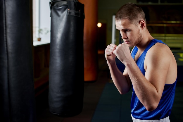 Boxing. Portrait of a boxer on the background of the gym