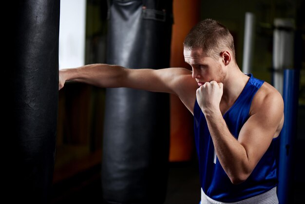 Boxing. Portrait of a boxer on the background of the gym