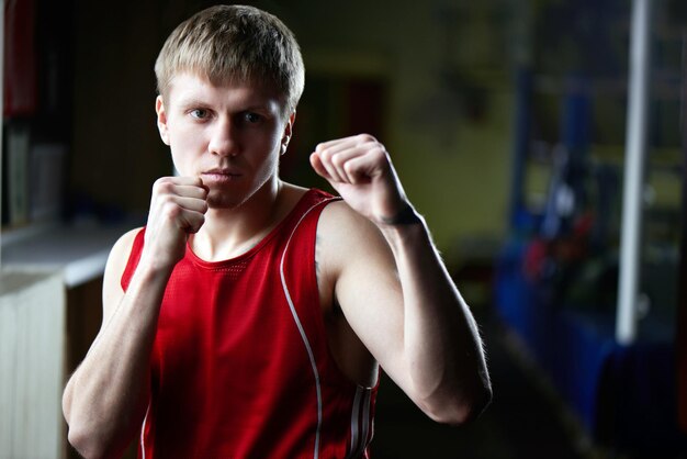 Boxing. Portrait of a boxer on the background of the gym