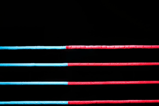 Boxing ring ropes on a black background. The concept of sports, mixed martial arts. Mixed media