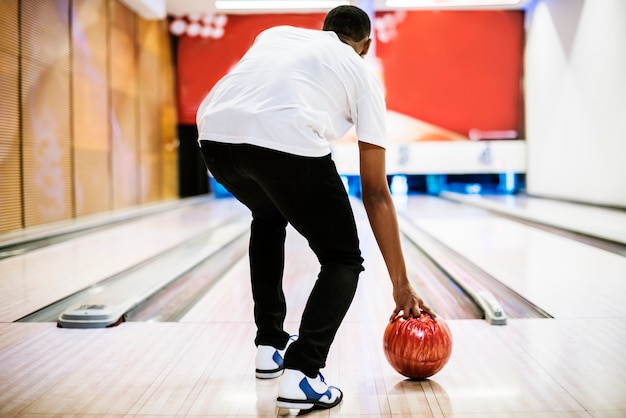 Boy about to roll a bowling ball hobby and leisure concept