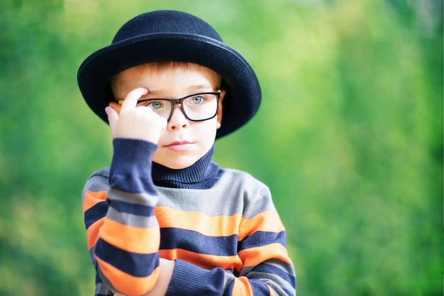 Boy as a movie actor or showbiz star Black hat and striped