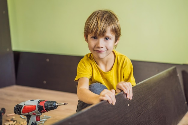 Boy assembling furniture Boy helping his dad at home Happy Family concept