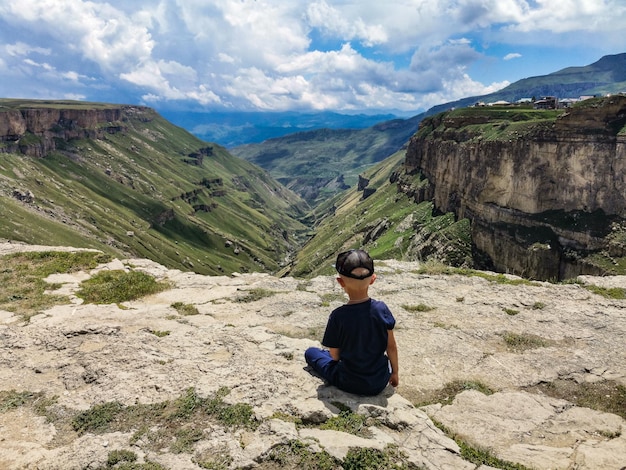 A boy on the background of the Khunzakh Valley Khunzakh waterfalls Dagestan 2021