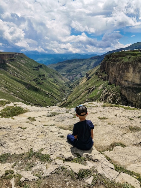 A boy on the background of the Khunzakh Valley Khunzakh waterfalls Dagestan 2021