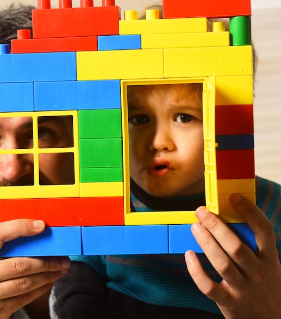 Foto ragazzo e uomo barbuto giocano insieme gioco di famiglia e infanzia