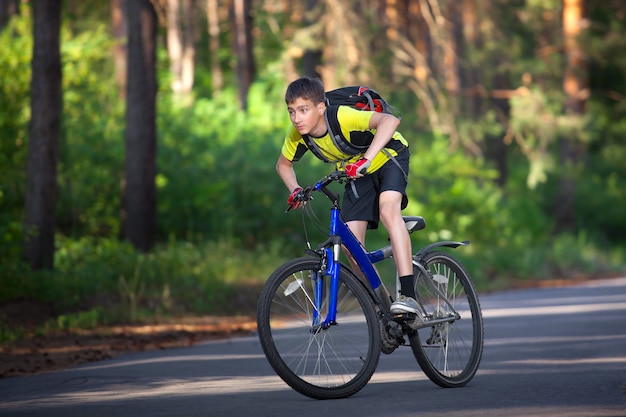 Boy on a bicycle traveling in the forest