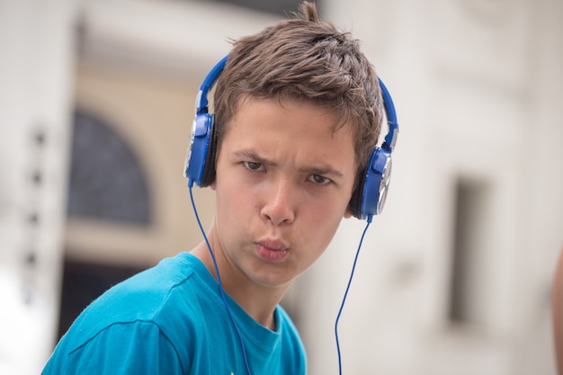 Boy in blue T-shirt and blue headphones