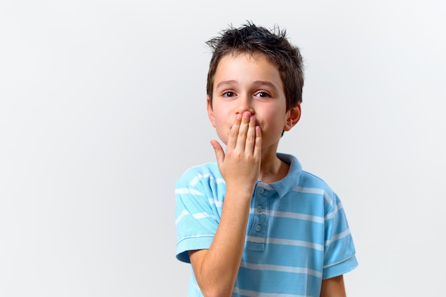 The boy in a blue T-shirt sends an air kiss.