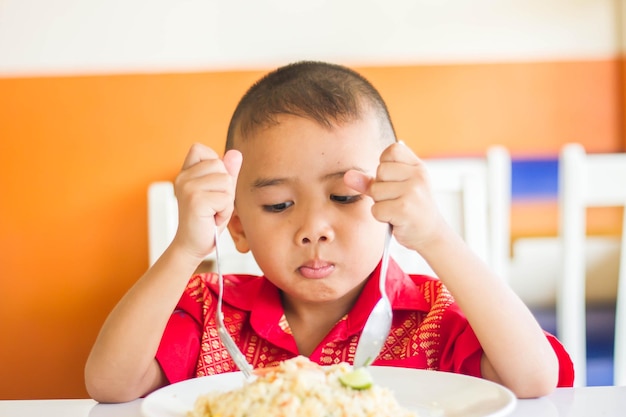 Boy by food at home