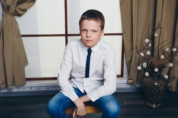 Boy by the window. child looking out. Concept oflife style, holidays