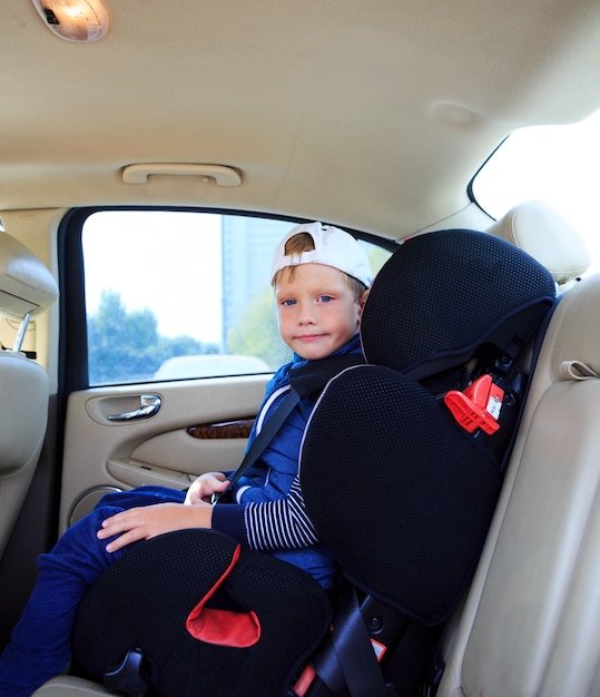 Boy in car safety seat